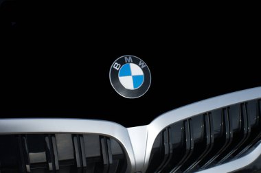 OCALA, FLORIDA - 2 NOVEMBER 2023 BMW logo emblem on black car hood front. Bavaria motor works is a German multinational manufacturer of luxury vehicles and motorcycles headquartered in Munich, Germany clipart