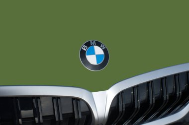 OCALA, FLORIDA - 2 NOVEMBER 2023 BMW logo emblem army green car front. Bavaria motor works is a German multinational manufacturer of luxury vehicles and motorcycles headquartered in Munich, Germany clipart