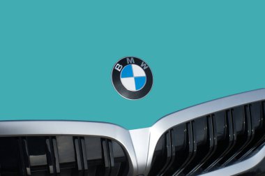 OCALA, FLORIDA - 2 NOVEMBER 2023 BMW logo emblem emerald green car hood front. Bavaria motor works German multinational manufacturer of luxury vehicles and motorcycles headquartered in Munich, Germany clipart