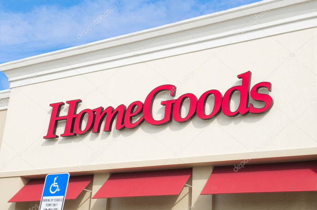 Ocala, Florida March 24, 2024 Homegoods red letter signage facade on exterior of building above entrance with blue sky background.  handicapped parking sign visible and red awnings
