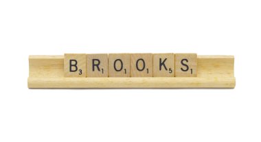 Miami, FL 4-18-24 popular baby boy first name of BROOKS made with square wooden tile English alphabet letters with natural color and grain on a wood rack holder isolated on white background clipart