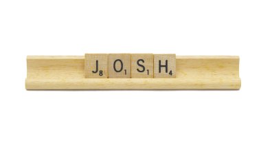 Miami, FL 4-18-24 popular baby boy first name of JOSH made with square wooden tile English alphabet letters with natural color and grain on a wood rack holder isolated on white background clipart