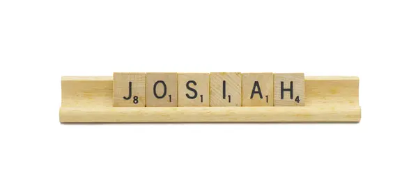 stock image Miami, FL 4-18-24 popular baby boy first name of JOSIAH made with square wooden tile English alphabet letters with natural color and grain on a wood rack holder isolated on white background