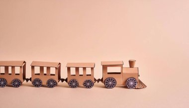 cute choo choo train toy train locomotive for kid, engine, wagon, wheels and railway, railroad conductor idea for a child.  concept paper origami isolated on light or white background with copy space clipart