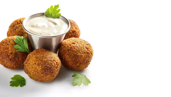 stock image Falafel are deep fried fritter balls made of spiced ground chickpeas or fava beans tzatziki dipping yogurt sauce that are popular in Israeli and Middle Eastern cuisine. Isolated on white background