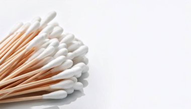 Pile of cotton swabs or q tip. Used to clean ears, remove make up, cleaning and arts and crafts. Eco friendly sustainable life style concept isolated on white background with copy space clipart