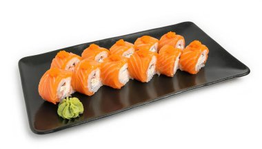 Salmon sushi on black plate sashimi uncooked fish with rice isolated on a White background, Japanese food healthy eating high protein low carbohydrate, popular cuisine worldwide