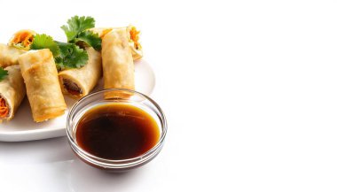 fried Spring Roll on plate commonly made with chicken, shrimp, or pork. With a side of soy sauce. Vietnamese Food isolated on white background with copy space clipart