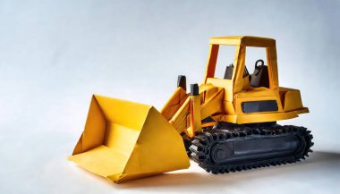 Kağıt origami kavramı, buldozer, dozer ya da sürüngen. Metal bir bıçakla donatılmış büyük bir makine. Toprak, kum, kar, moloz ya da kaya gibi maddeleri itmek için. İzole edilmiş beyaz