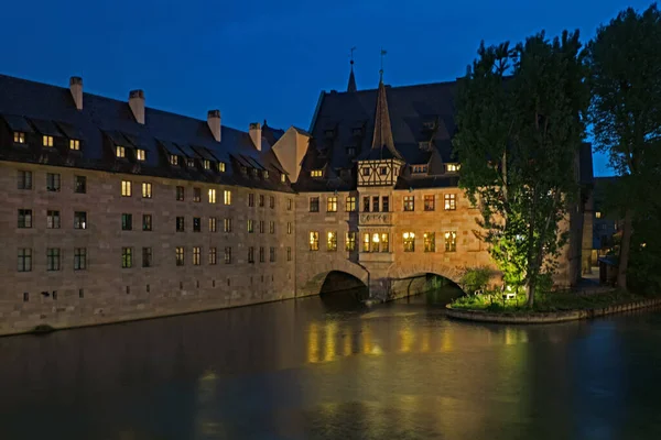 Historic Holy Ghost Hospital on the Pegnitz River in the Old Town of Nuremberg at Blue Hour, Germany