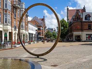 Hjorring, North Jutland, Denmark - 18 June, 2024: View of the old town with historic houses and a modern fountain clipart