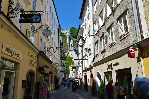 Salzburg, Austria - June 14 2023: Street in Salzburg city with Bergerspitalkirche St. Blasius catholic church