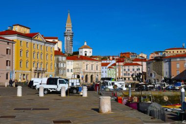 Piran, Slovenia - November 16 2024: St. George's Parish Church from the harbour in the coastal town of Piran in Istria, Slovenia clipart