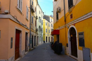 Piran, Slovenia - November 16 2024: Narrow street in the old town of Piran in Istria, Slovenia clipart