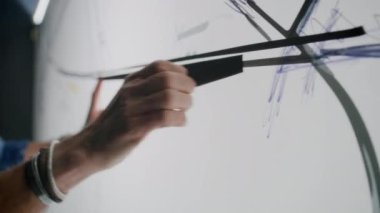 Otomotiv erkek mühendisi kağıt beyaz tahtada koli bandıyla robot resim çiziyor ve yeni nesil elektrikli araba geliştiriyor. Modern araba tasarım stüdyosunda çalışıyor..