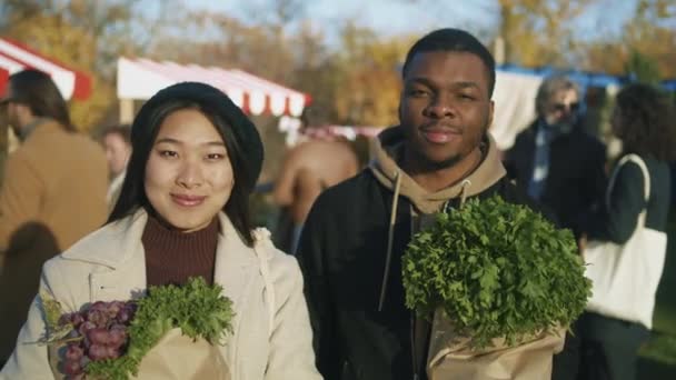 Diverse Couple Standing Paper Bags Vegetables Fruits Spouses Looking Camera — Stock Video