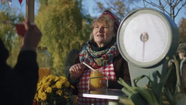 Äldre Säljare Står Vid Stallet Ger Honung Smak Folk Betalar — Stockvideo