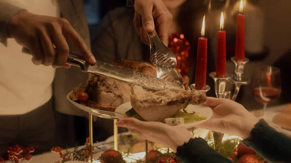 칠면조나 닭고기를 자르는 남자의 크리스마스나 추수감사절을 기념하는 문화적 접시와 양초로 — 스톡 사진