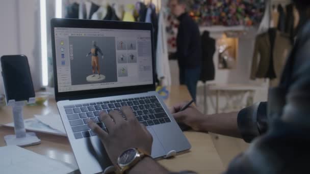 African American Fashion Designer Draws Clothes Modeling Program Laptop Using — Stockvideo
