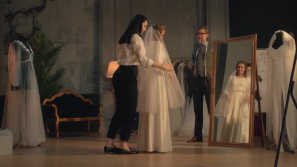 Cinematic Shot Female Tailor Fixing Veil Woman Wedding Dress Front — Stockvideo