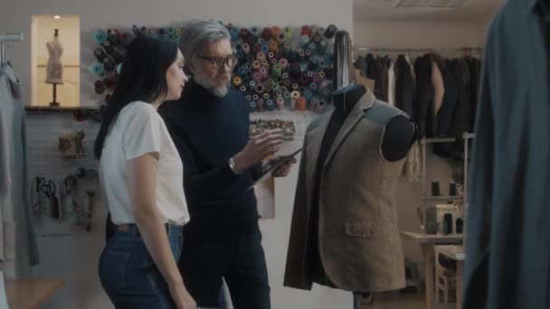 Male Mature Fashion Designer Shows Drawing Future Jacket Female Tailor — Stockvideo