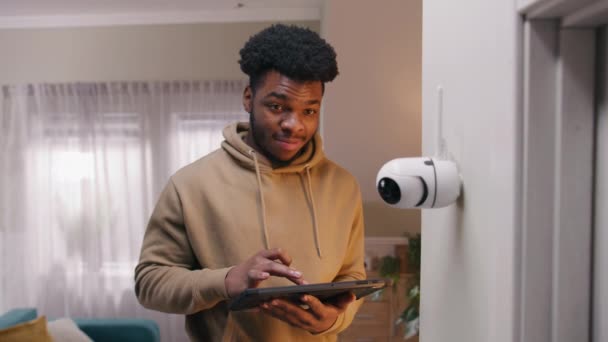 African American Man Installs Security Camera Man Sets Angle Cctv — 图库视频影像