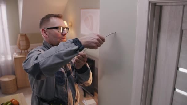 Man Uniform Puts Cable Drilled Hole Electrician Removes Insulation Wire — Vídeo de Stock