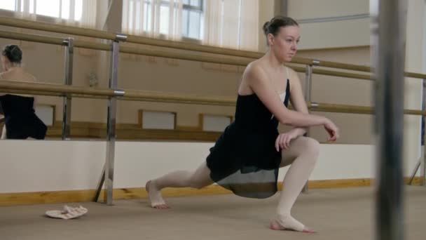 Female Ballet Dancer Training Suit Makes Lunges Stretches Legs Practice — Vídeo de Stock