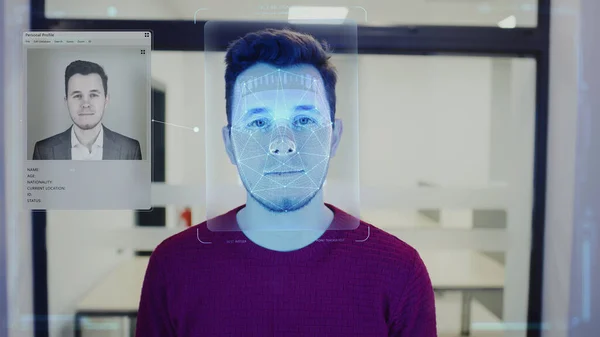 Man scans face in office. He touches sensor and security system identifies person for access. 3D hologram of human innovative biometric facial recognition. Privacy, identification and AI technology.