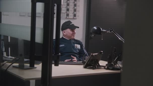 Adult Security Officer Sits Workplace Talks Colleague Looks Computers Screen — Stock Video