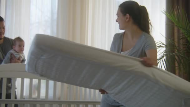 Caring Mother Puts Mattress Blanket Child Toys Baby Cradle Happy — Stock Video