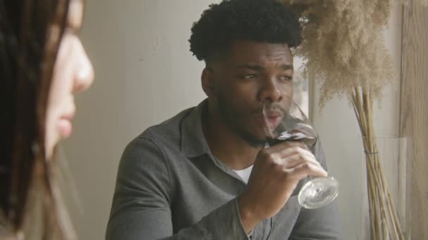 African American Man Sits Table Window Talks Asian Woman Drinks — Stock Video