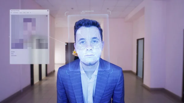 Businessman scans his face in office. Security system software identifies person, shows personal profile. 3D hologram of human biometric facial recognition. Identification, privacy, and AI technology.