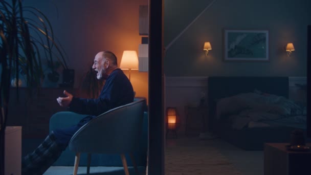 Elderly Man Watch Movie Laughs Late Night Man Insomnia Irritated — Stock Video