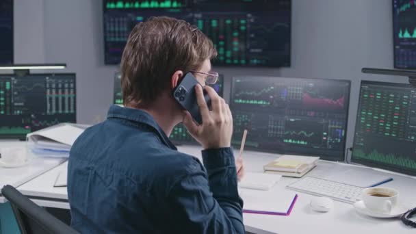 Erkek Borsacı Telefonla Konuşuyor Bankada Çoklu Monitörde Çalışıyor Gerçek Zamanlı — Stok video