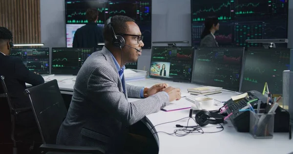 手握钢笔的非裔美国商人在电脑上工作 拥有实时股票 同事们在大屏风的背景下分析外汇市场图表 贸易和投资的概念 — 图库照片