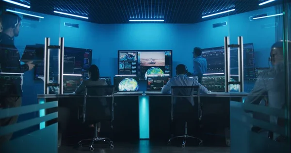 Team watch successful space rocket launch on big digital screens in mission control center. Diverse flight control workers in front of computers monitor crewed mission. Scientific space exploration.