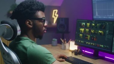 Afrikalı Amerikalı renkçi aksiyon filmi düzenliyor, renk düzeltmesi yapıyor, evde çalışıyor. Bilgisayar ve büyük dijital ekranda RGB araçları ve tekerlekleriyle program arayüzü. Film sonrası prodüksiyon kavramı.
