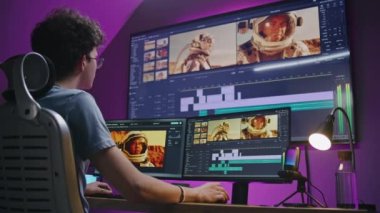 Genç editör, video yapımcısı astronotlarla film müzikleri düzenliyor, ev ofisinde çalışıyor. Bilgisayar ve büyük dijital ekrandaki araçlarla film görüntüleri ve program arayüzü. Yapım konsepti.