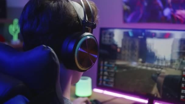 Young Boy Headphones Plays First Person Shooter Gamer Enjoys Online — Stock Video
