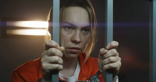 Shocked Female Prisoner Orange Uniform Holds Metal Bars Stands Prison — Stock Photo, Image