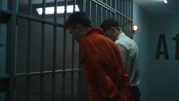 Prison Officer Opens Prison Cell Male Prisoner Orange Uniform Jailer — Stockvideo