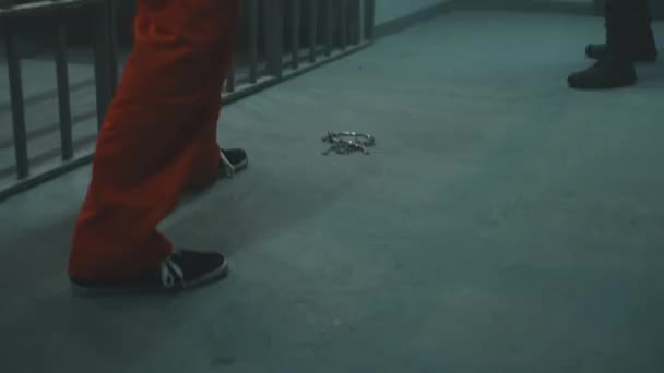 Prisoner Orange Uniform Stands Prison Cell Pushes Keys His Foot — Video