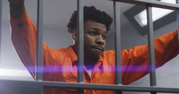 Sad African American Man Orange Uniform Leans Hands Prison Cell — Stock Photo, Image