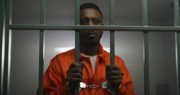 African American Prisoner Orange Uniform Keeps Hands Handcuffs Jail Cell — Stock Photo, Image