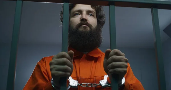 Turuncu Üniformalı Bir Erkek Mahkum Metal Parmaklıklar Tutuyor Hapishane Hücresinde — Stok fotoğraf