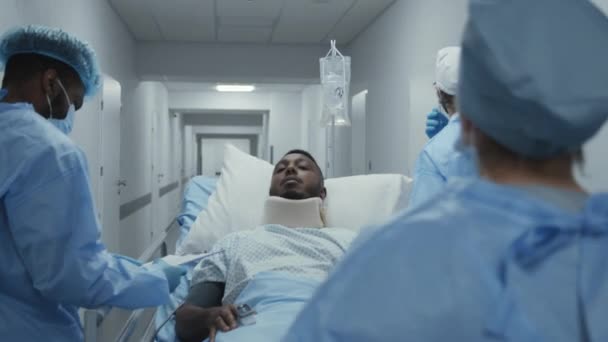 Doctors Paramedics Push Stretcher Patient Surgery Room African American Man — Stock Video