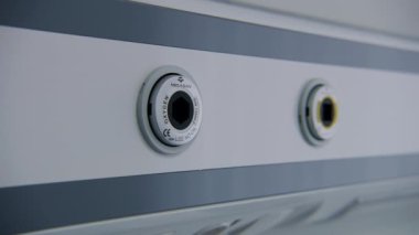 ZAPORIZHYA, UKRAINE - 30 Haziran 2023: Hasta başucu panelindeki oksijen ve vakum bağlantılarını kapatın. Hastane koğuşunda yatağın üstündeki duvarda asılı olan kontrol paneli. Klinikte modern ekipman