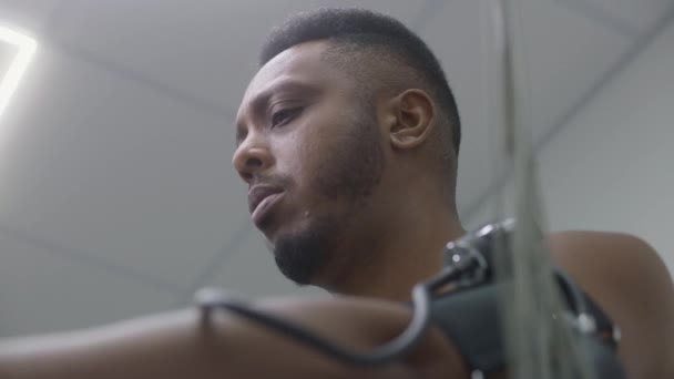African American Man Patient Tonometer Pedals Orbitrek Cardiology Room Electrocardiography — Stock Video