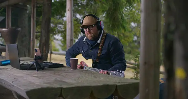 Caucasian Man Headphones Plays Guitar Records Music Sitting Wooden Gazebo — Stock Photo, Image